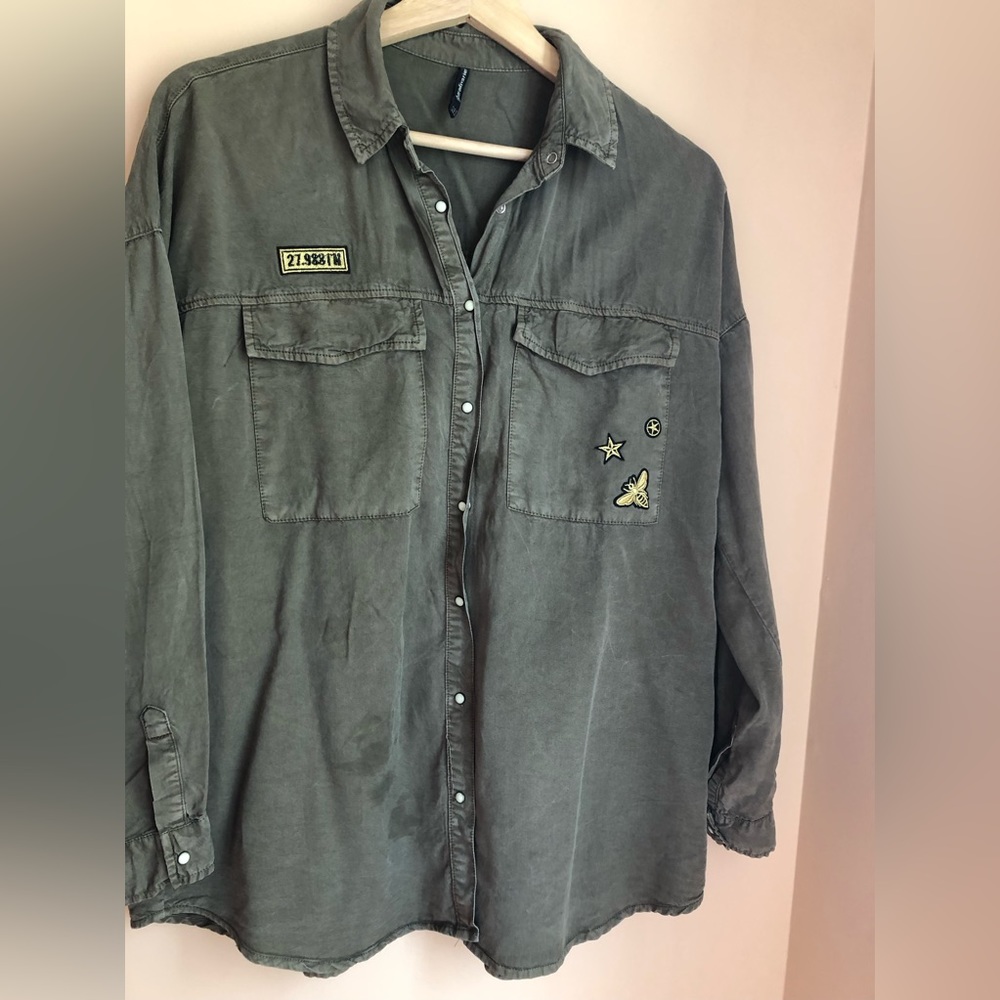 Cool washed shacket in forest green and gold embroidery.